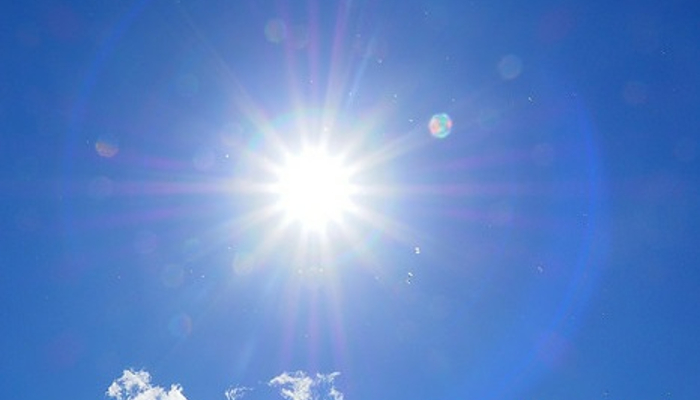Colour photo of the Sun shining in a clear blue sky.  