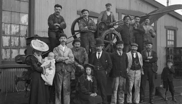 Image: Group outside one of the Petone railway workshops (https://natlib.govt.nz/records/22775992) by Albert Percy Godber. Collection: Alexander Turnbull Library, Ref: APG-0127-1/2-G.