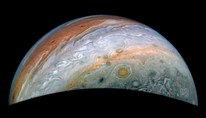 Colour image of Jupiter showing stripes and spots. The stripes are cloud bands and the spots are storms.