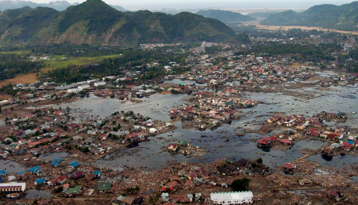 Image: US Navy 050102-N-9593M-040 A village near the coast of Sumatra lays in ruin after the Tsunami that struck South East Asia (https://commons.wikimedia.org/wiki/File:US_Navy_050102-N-9593M-040_A_village_near_the_coast_of_Sumatra_lays_in_ruin_after_the_Tsunami_that_struck_South_East_Asia.jpg) by U.S. Navy on Wikimedia Commons. Public Domain. Image cropped.
