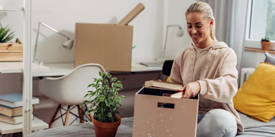 Woman on laptop with MoneySuperMarket logo displayed