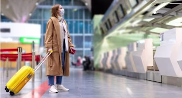 Woman on laptop with MoneySuperMarket logo displayed