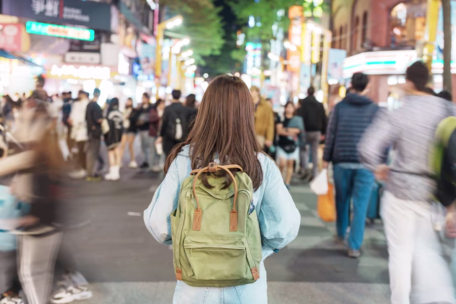 Backpacker in busy city