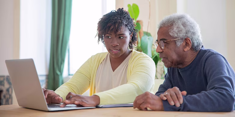 mature man and woman using laptop together