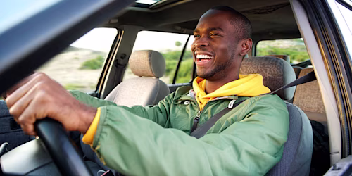 happy male driving car