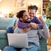 Woman on laptop with MoneySuperMarket logo displayed