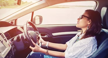 Woman on laptop with MoneySuperMarket logo displayed