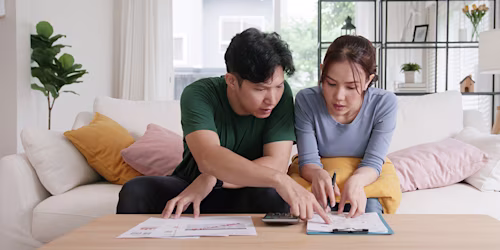 couple calculating household budget savings