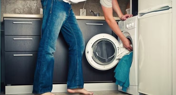 Man putting washing into machine