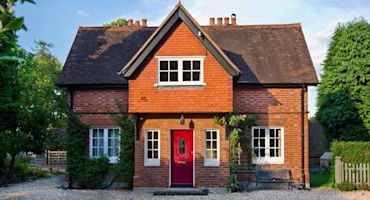 Woman on laptop with MoneySuperMarket logo displayed