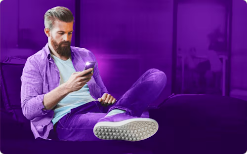 Man sitting with a boy holding a camera