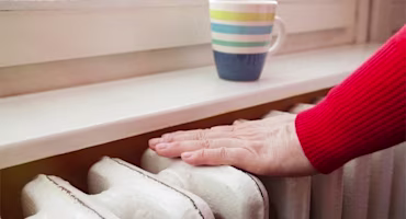 Woman on laptop with MoneySuperMarket logo displayed