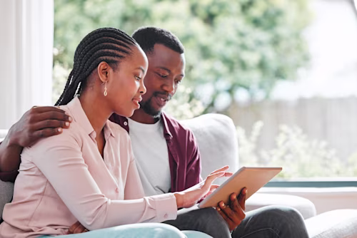 Black couple looking at a tablet