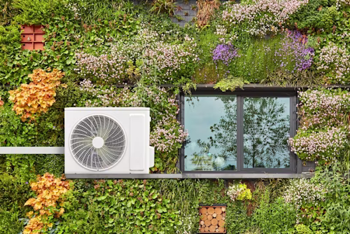 Heat pump on green wall