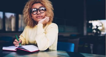Woman on laptop with MoneySuperMarket logo displayed
