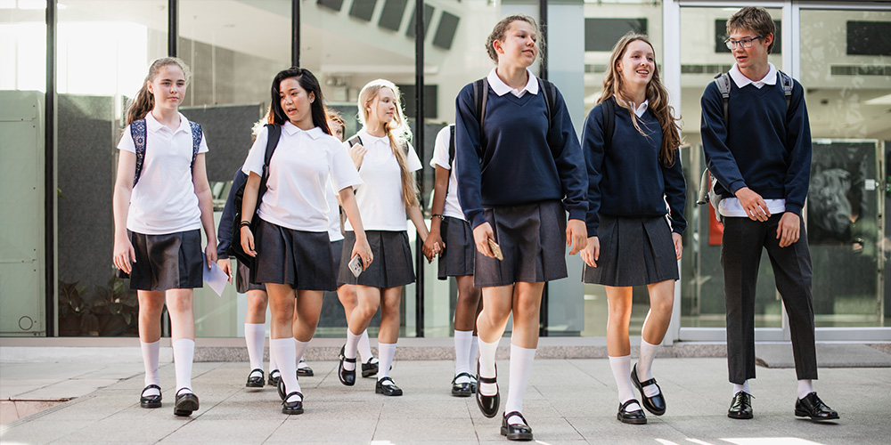 students in uniform walking to school