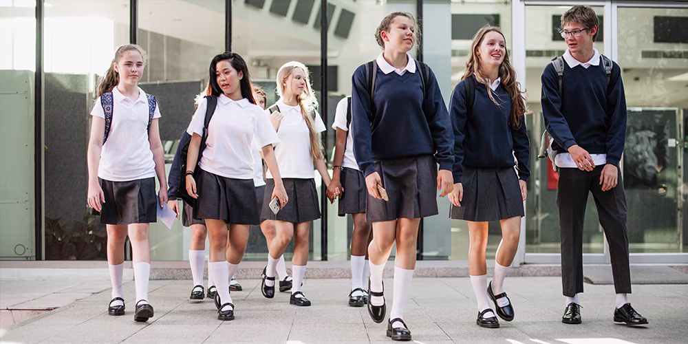 students in uniform walking to school