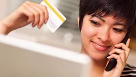 Woman on laptop with MoneySuperMarket logo displayed