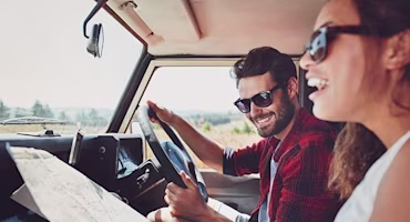Woman on laptop with MoneySuperMarket logo displayed