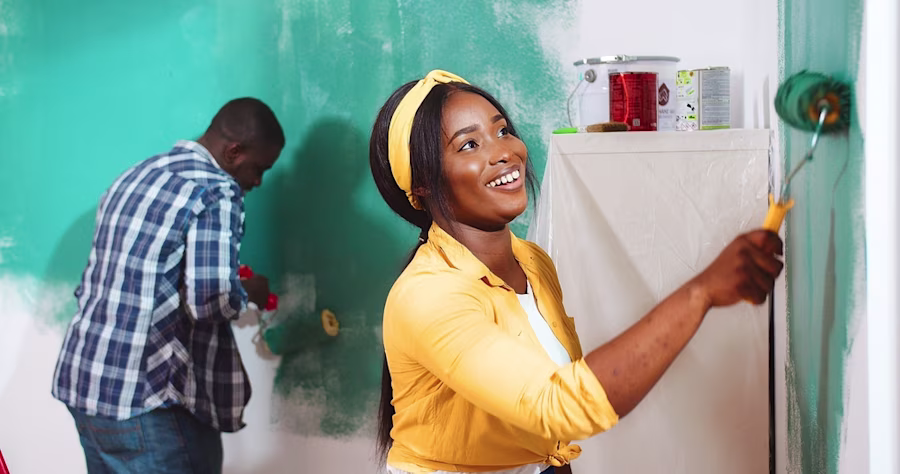 Couple painting the walls of their home