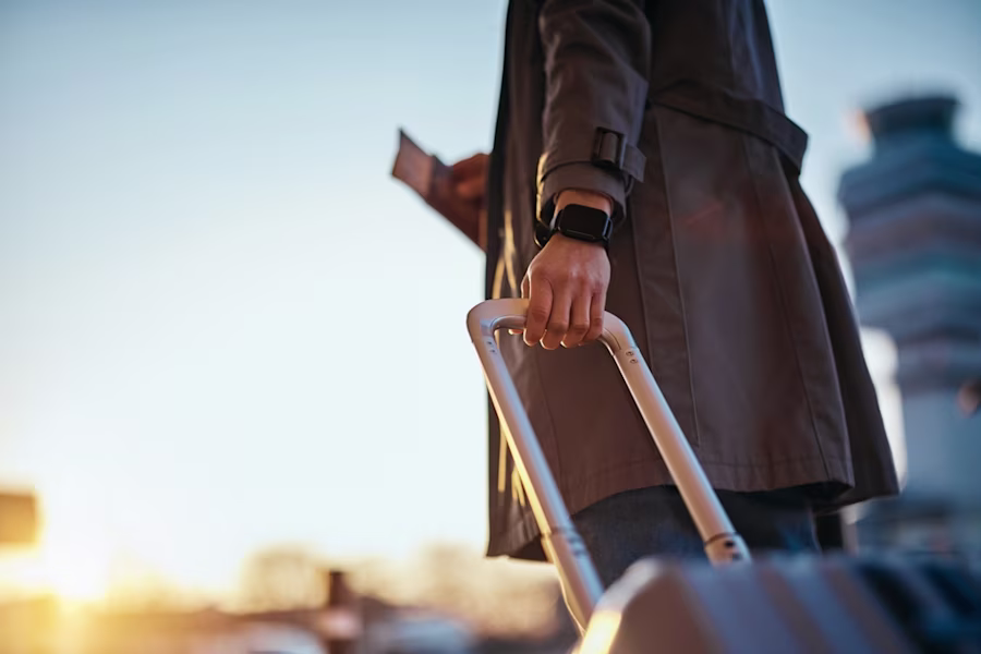 Woman at an airport with suitcase
