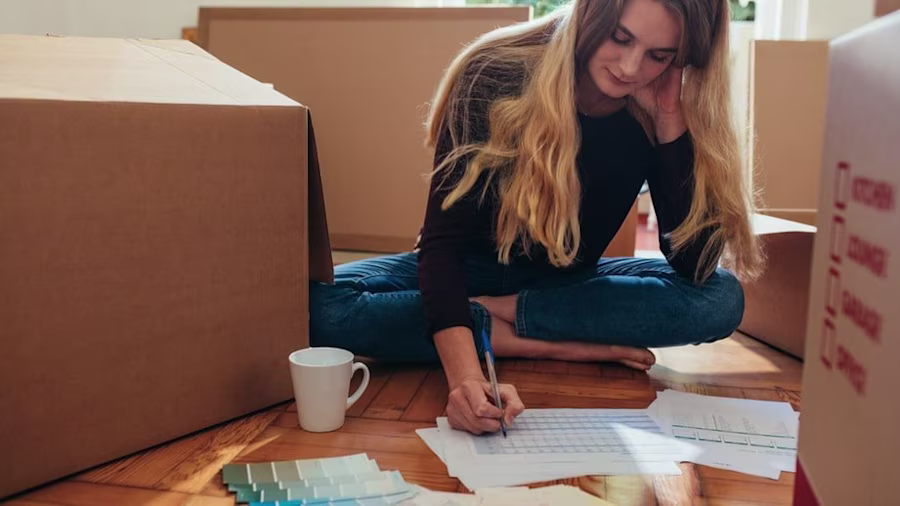 Woman using checklist to pack her possessions