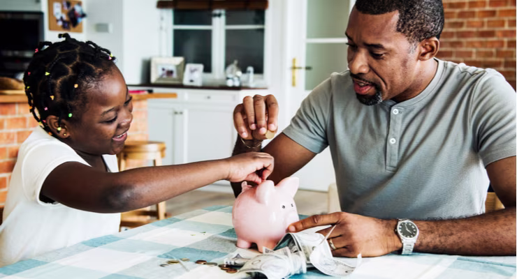 Dad with child and piggy bank