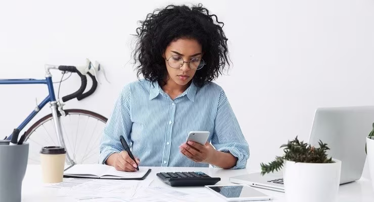 woman at desk with phone