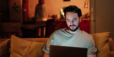 Woman on laptop with MoneySuperMarket logo displayed