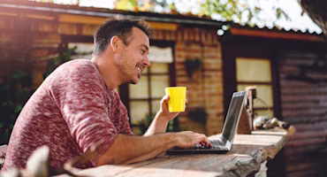 Woman on laptop with MoneySuperMarket logo displayed