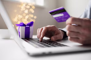 Woman on laptop with MoneySuperMarket logo displayed