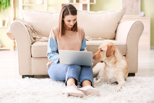 woman on laptop with dog