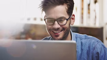Woman on laptop with MoneySuperMarket logo displayed