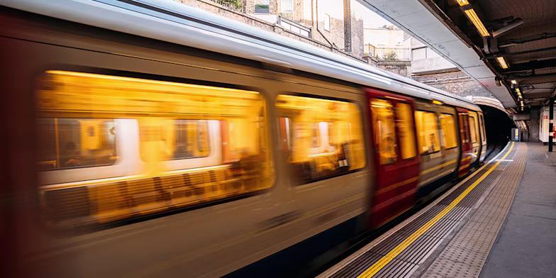 train driving through station