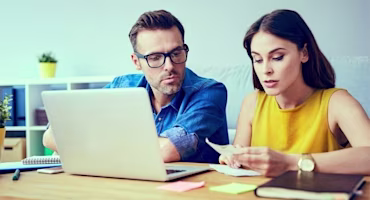 Woman on laptop with MoneySuperMarket logo displayed