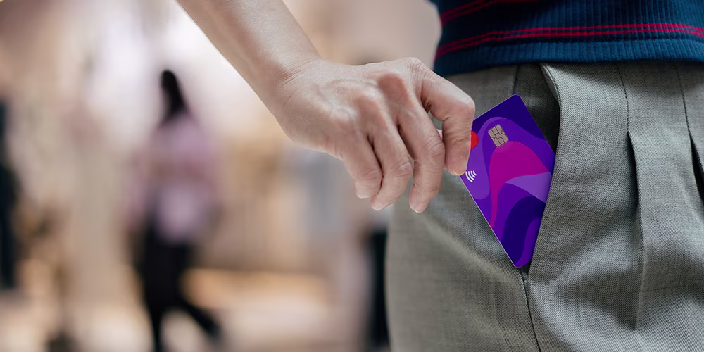 A woman placing a contactless credit card into her pocket