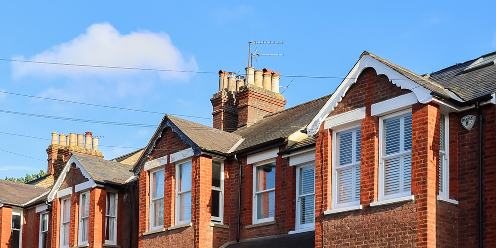 Victorian English houses under blue sky