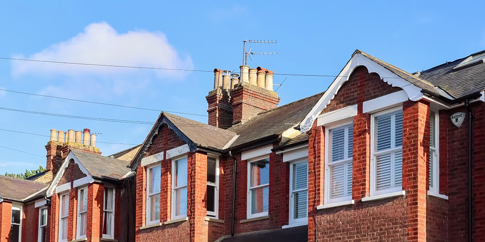 Victorian English houses under blue sky