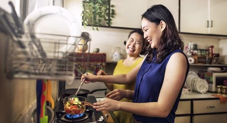 Mother and daughter cooking together
