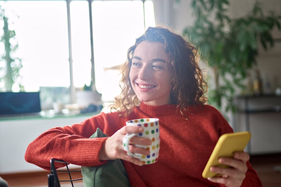 Woman using phone smiling