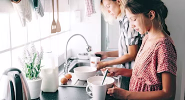 Woman on laptop with MoneySuperMarket logo displayed