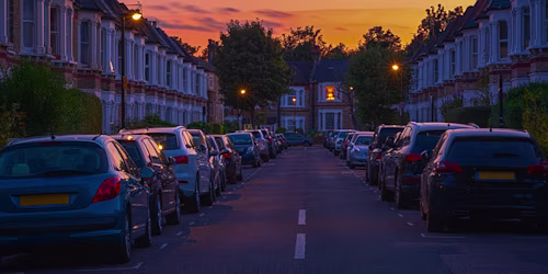 cars parked outside houses at night