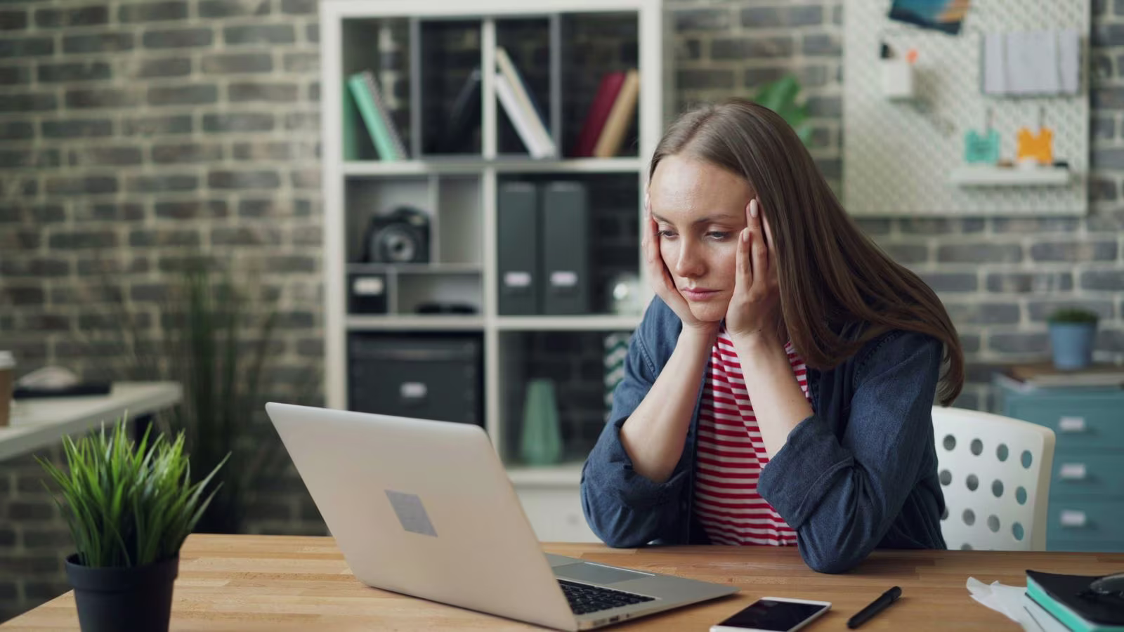 Woman looking at laptop.