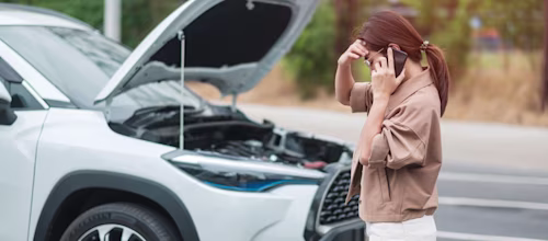 Person next to broken down car
