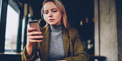 Woman on laptop with MoneySuperMarket logo displayed