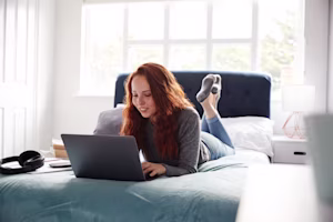 Woman on laptop with MoneySuperMarket logo displayed