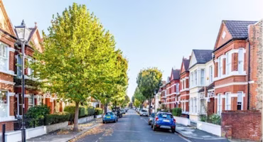 Woman on laptop with MoneySuperMarket logo displayed