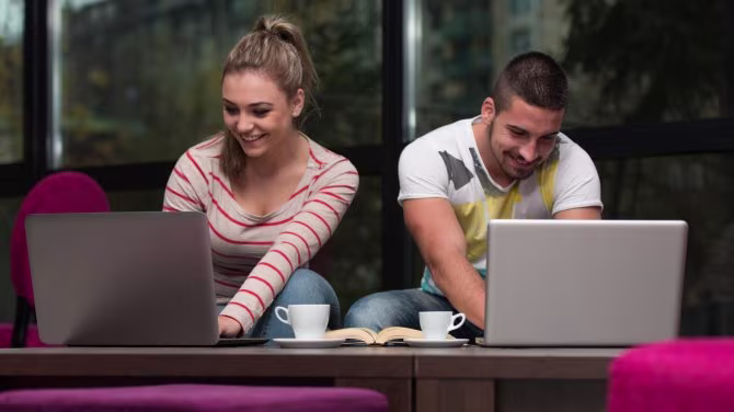 A man and a woman using a laptop