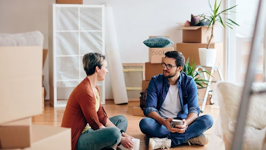 Man and woman sitting on the floor