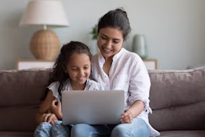 Woman on laptop with MoneySuperMarket logo displayed